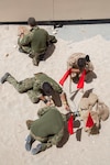 Explosive Ordnance Disposal Technicians and members of the Bahrain Defense Force (BDF) train on a rocket wrench, which is used to disrupt fuses on unexploded ordnance at the BDF military operations urban terrain site during Neon Response 19. Neon Response is a bilateral explosive ordnance disposal and maritime security exercise between the U.S. Navy and BDF conducted to share knowledge and experiences to enhance mutual capabilities and interoperability. (U.S. Army photo by Staff Sgt. Sidney Weston/Released)