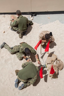 Explosive Ordnance Disposal Technicians and members of the Bahrain Defense Force (BDF) train on a rocket wrench, which is used to disrupt fuses on unexploded ordnance at the BDF military operations urban terrain site during Neon Response 19. Neon Response is a bilateral explosive ordnance disposal and maritime security exercise between the U.S. Navy and BDF conducted to share knowledge and experiences to enhance mutual capabilities and interoperability. (U.S. Army photo by Staff Sgt. Sidney Weston/Released)