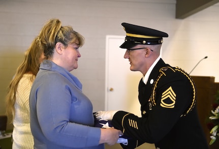 Shelley Statler, pictured receiving the flag from a member of the Wyoming Army National Guard Military Funeral Honors team.