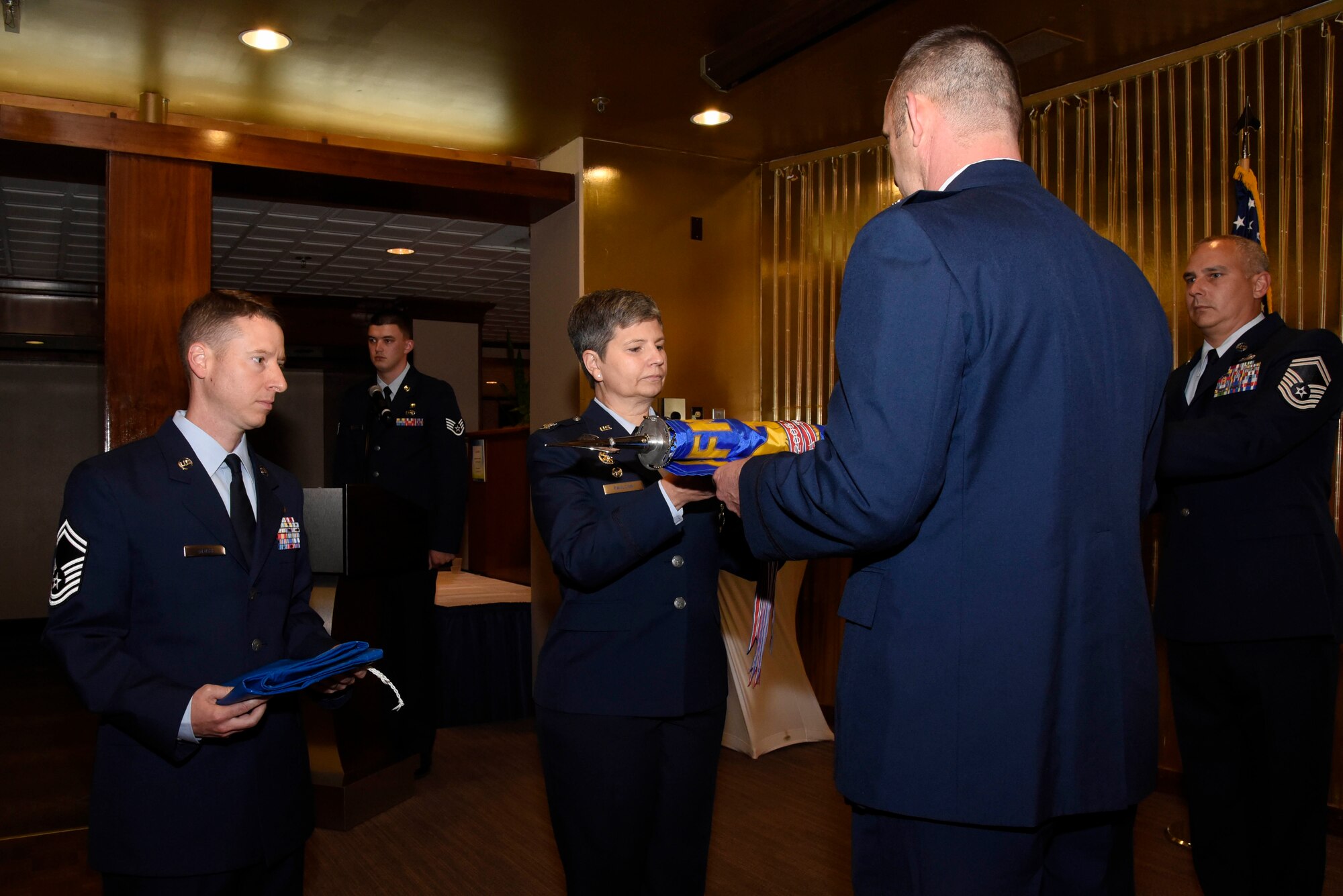 Lt. Col. Ryan Caulk (right), 4th Manpower Requirements Squadron commander, inactivates command of the squadron June 17, 2019 at The Club on Peterson Air Force Base, Colorado. The squadron is now under the direction of the Air Force Manpower Analysis Agency and has become an Operating Location. Throughout its existence, the squadron earned two Air Force Outstanding Unit Awards and three Air Force Organizational Excellence Awards. (U.S. Air Force photo by Staff Sgt. Alexandra M. Longfellow)