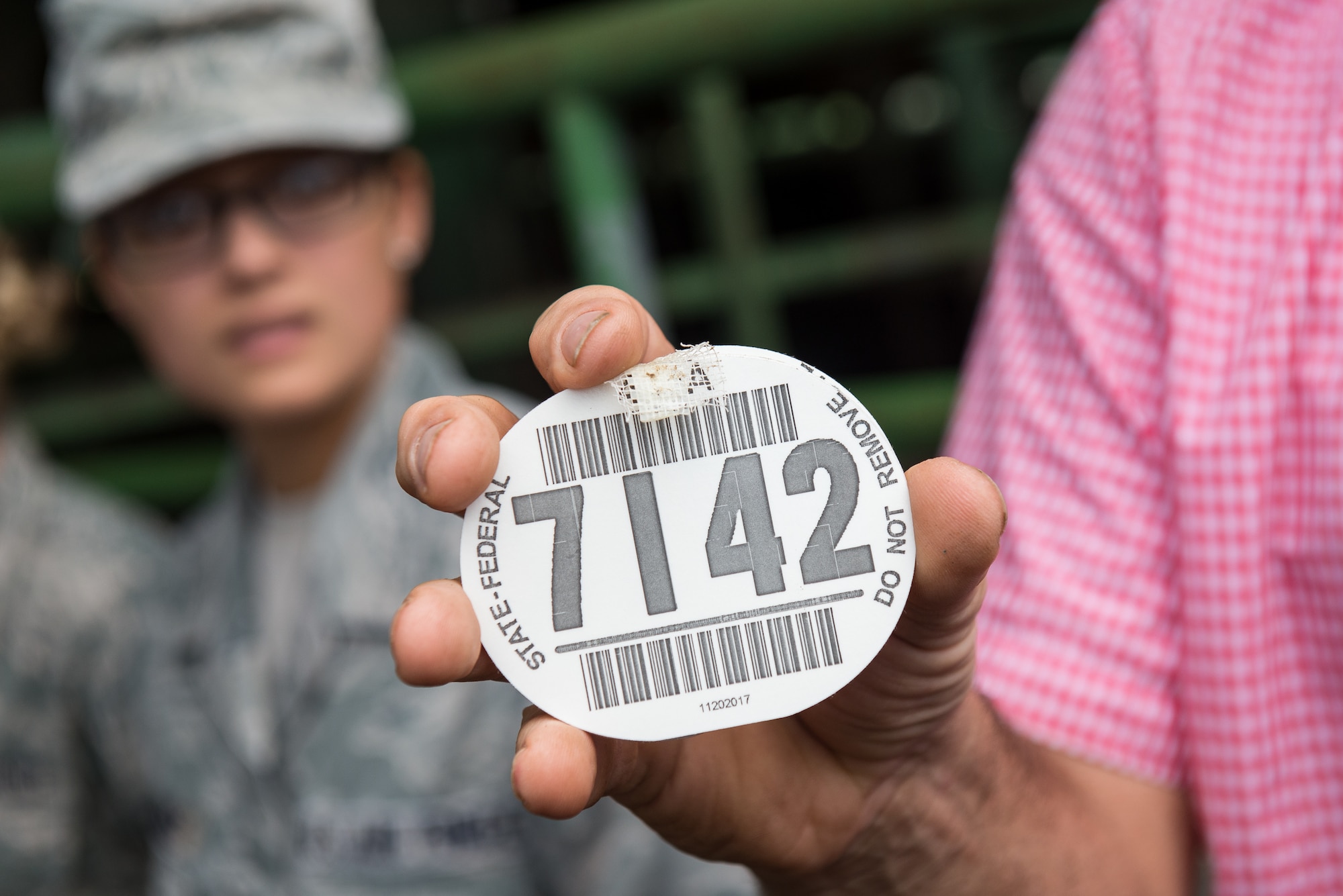 Neal Franke, the co-owner of SEMO Livestock Sales, displays a cattle tag, which is required for livestock sales by both federal and state regulators, during a public health site visit in Jackson, Mo., June 18, 2019. Among other purposes, the tags are used to track feeder livestock supply chains from farm to table to ensure public health regulations are followed. (U.S. Air National Guard photo by Senior Airman Jonathan W. Padish)