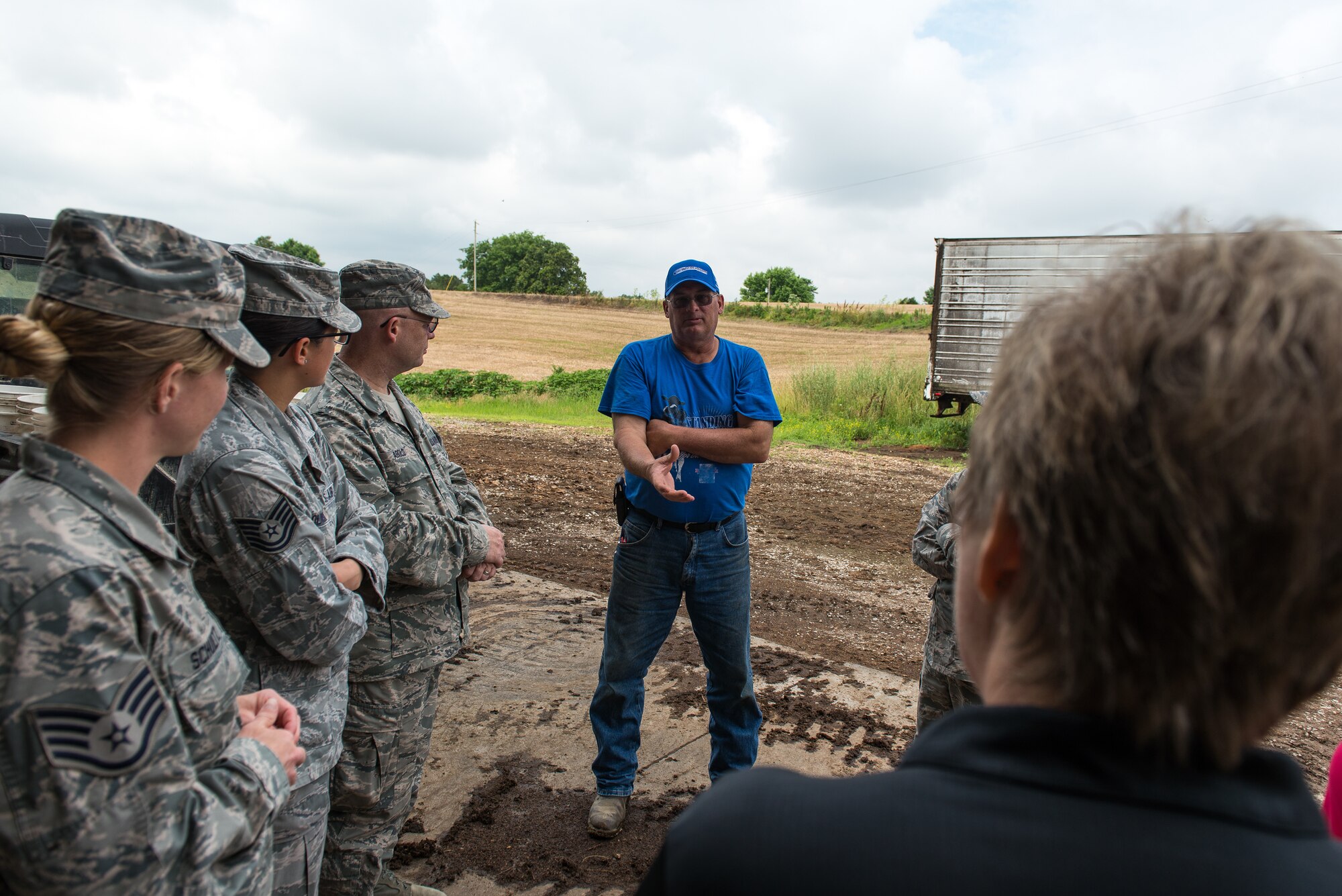 Wayne Lohmann, a farmer at Lohmann Farms, discusses dairy operations with U.S. Air Force public health professionals and representatives from the Cape Girardeau County Public Health Commission during a site visit in Perryville, Mo., June 18, 2019. Airmen deployed in support of Delta Area Economic Opportunity Corporation Tri-State Innovative Readiness Training 2019 coordinated with civilian public health agency partners to view livestock processes and promote interagency cooperation. (U.S. Air National Guard photo by Senior Airman Jonathan W. Padish)