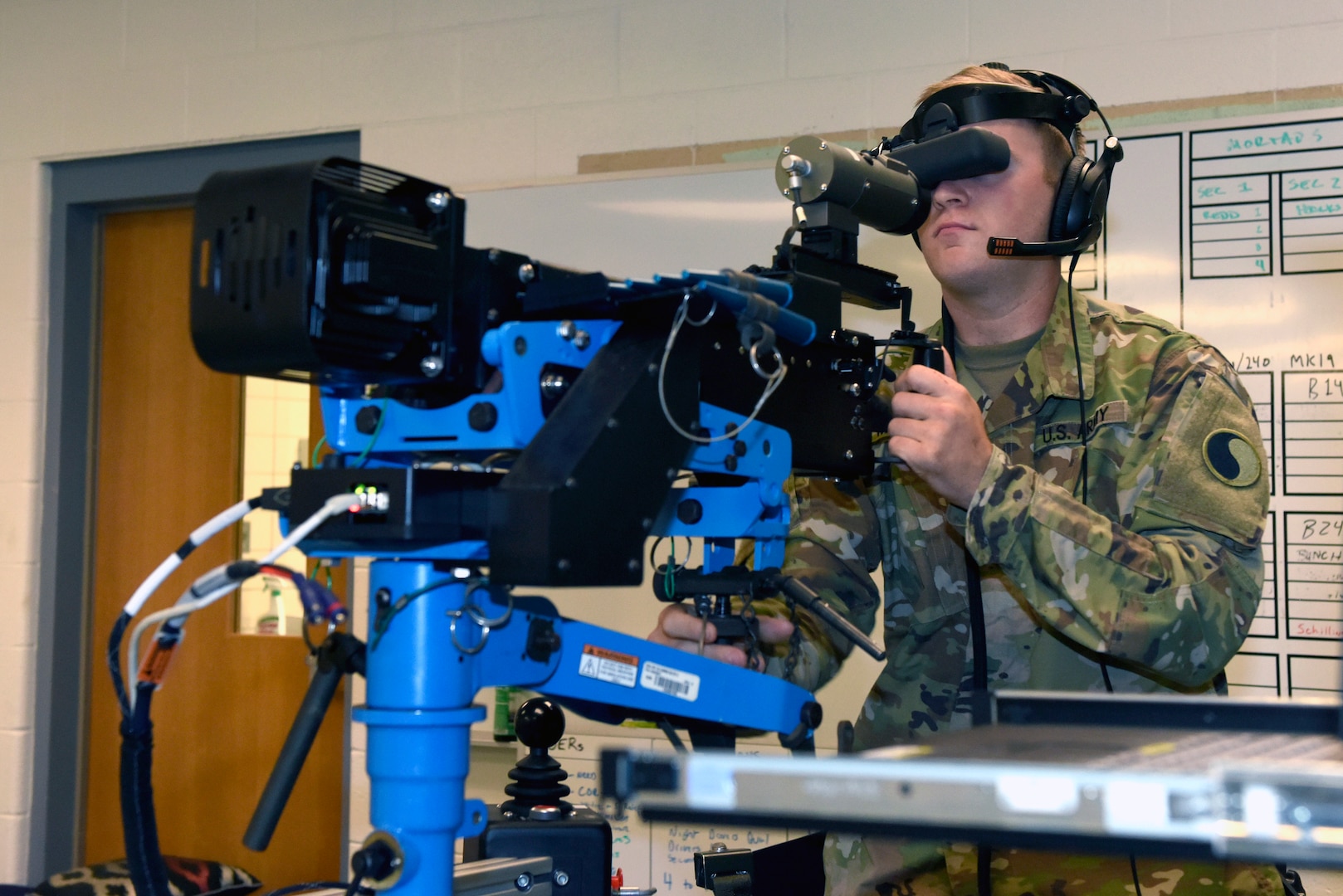 Spc. Erik Murphy, a cavalry scout with the Virginia Army National Guard's Troop B, 2nd Squadron, 183rd Cavalry Regiment, engages targets with an M2 .50 caliber machine gun on the Individual Unstabalized Gunnery Trainer during training at the Suffolk Armory in Suffolk, Virginia, June 8, 2019. The IUGT is a computer-based simulator that connects the body of a weapon to a virtual reality system and is used to augment the training on crew-served weapons.