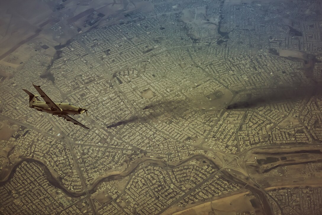 One aircraft flying over land.