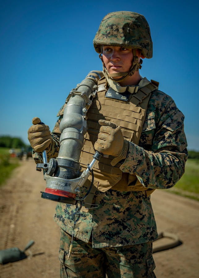 U.S. Marine Corps Lance Cpl. Ryan Shea, a bulk fuel specialist with Marine Wing Support Squadron 471, Marine Aircraft Group 41, 4th Marine Aircraft Wing, pulls a fuel hose during a Forward Arming and Refueling Point operation at Cold Lake Air Weapons Range, Alberta, Canada, June 18, 2019, in support of Sentinel Edge 19. MARFORRES squadrons participate in SE19 to both complete annual training requirements and to increase unit readiness and proficiency. (U.S. Marine Corps photo by Lance Cpl. Jose Gonzalez)