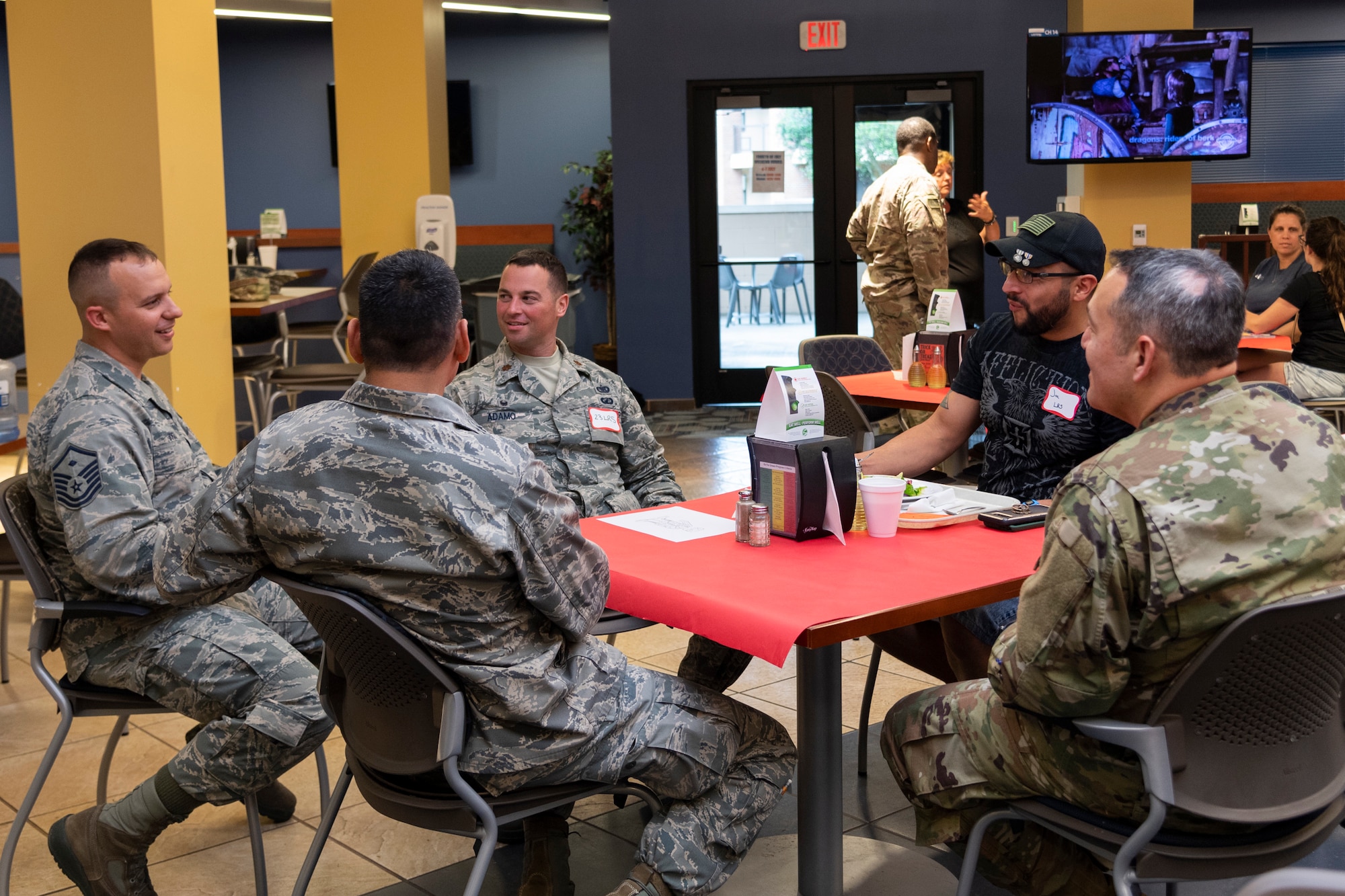 Airmen socialize during a deployed spouse dinner, June 18, 2019, at Moody Air Force Base, Ga. The dinner served as an opportunity for the families of deployed members to bond and provide relief. The mission's success depends on resilient Airmen and families, who are prepared to make sacrifices with the support of their fellow Airmen, local communities and leadership. (U.S. Air Force photo by Airman 1st Class Hayden Legg)
