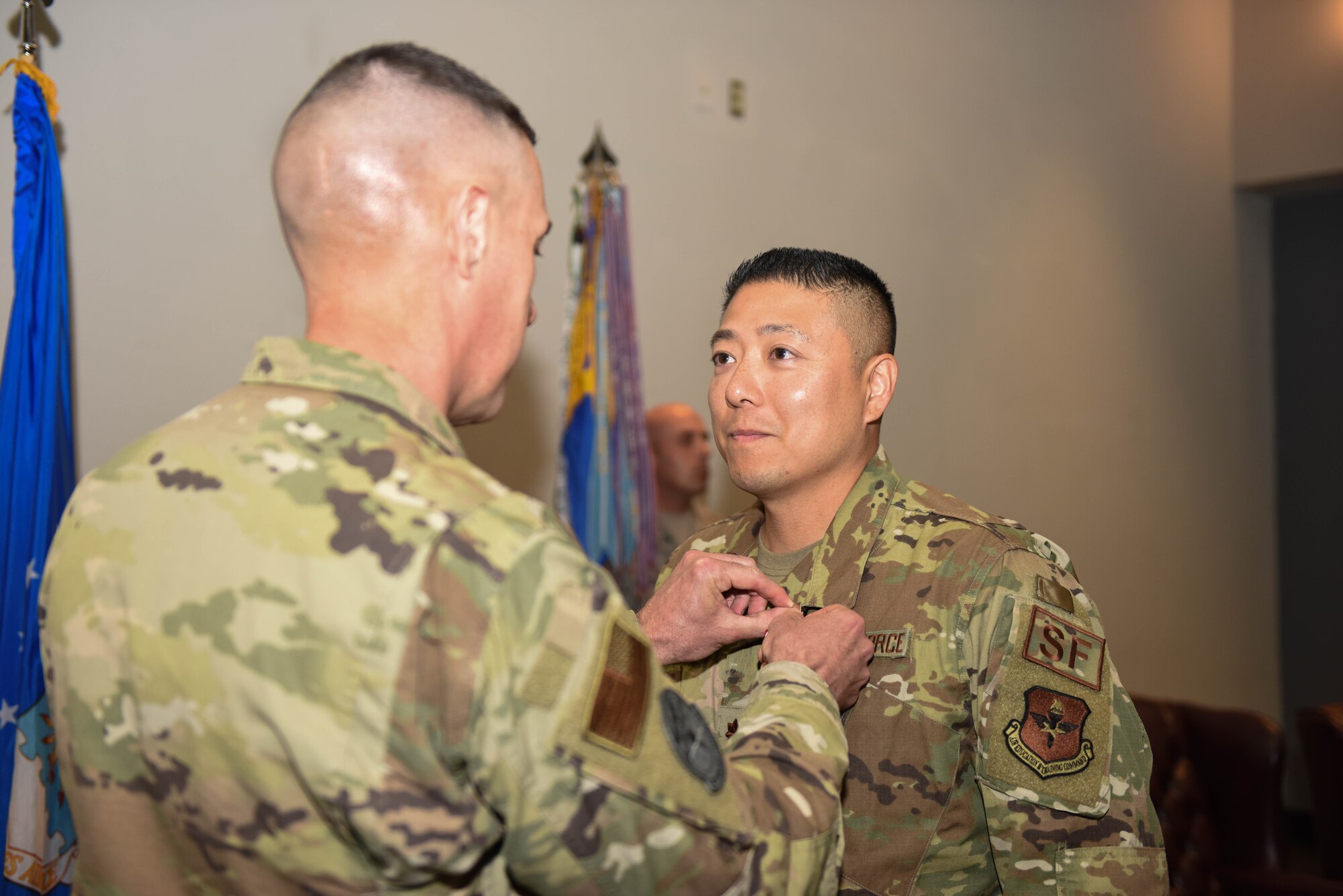 U.S. Air Force Col. Jason Beck, 17th Mission Support Group commander, pins the Meritorious Service Medal onto Maj. Min Lee, 17th Security Forces Squadron outgoing commander, during the 17th SFS Change of Command at the event center on Goodfellow Air Force Base, Texas, June 19, 2019. The Meritorious Service Medal is awarded to members of the United States Armed Forces who distinguish themselves by outstanding achievement or service. (U.S. Air Force photo by Senior Airman Seraiah Hines/Released)