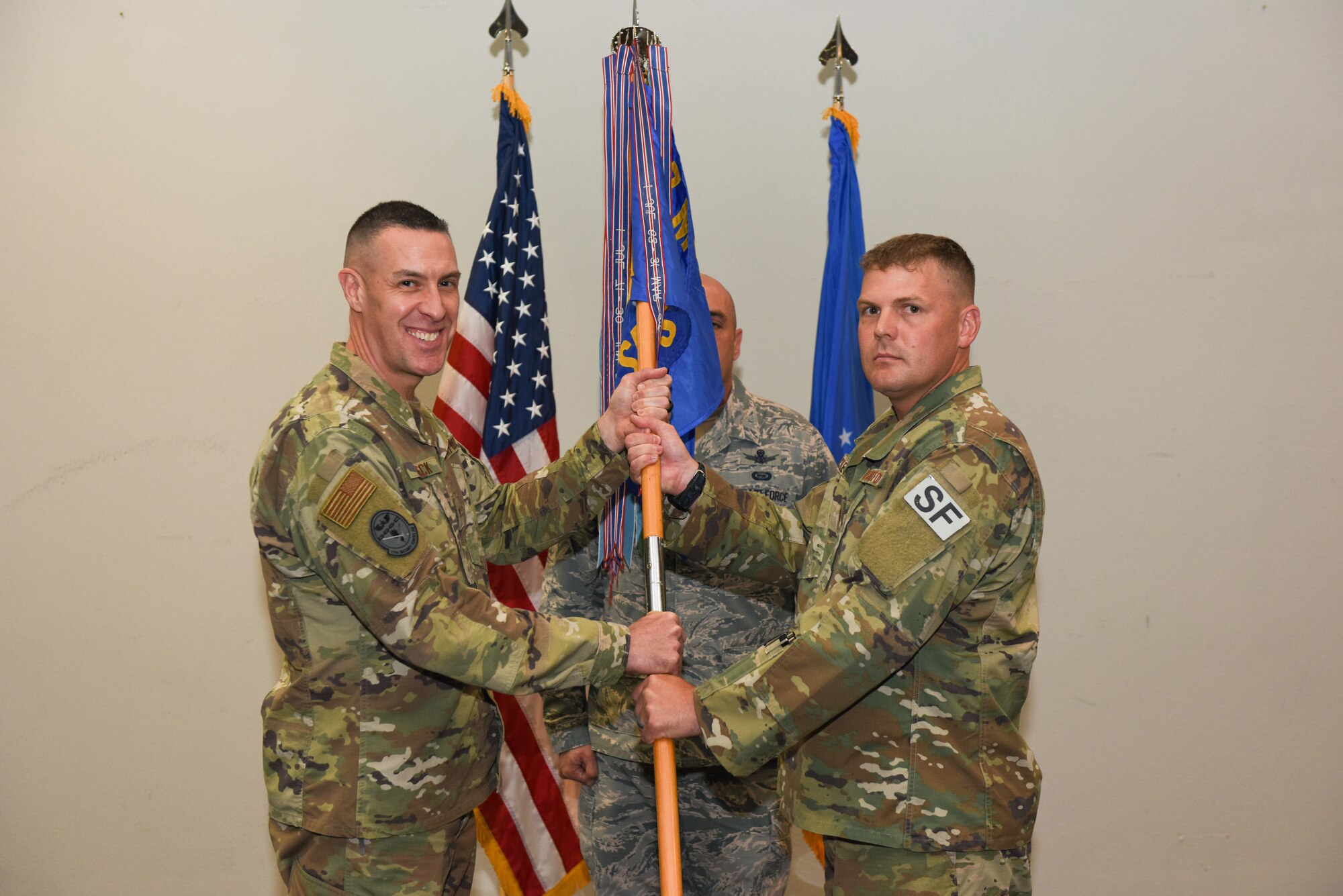 U.S. Air Force Col. Jason Beck, 17th Mission Support Group commander, presents Maj. Richard Buckley, incoming 17th Security Forces Squadron commander, with the guideon during the change of command ceremony at the event center on Goodfellow Air Force Base, Texas, June 19, 2019. Buckley commissioned through the Reserve Officer Training Corps as a distinguished graduate in 2005. (U.S. Air Force photo by Senior Airman Seraiah Hines/Released)