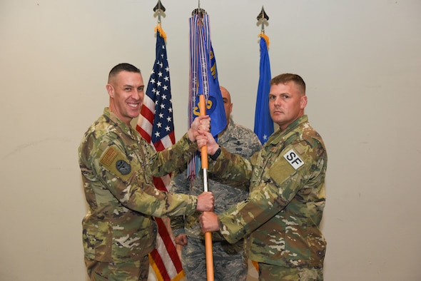 U.S. Air Force Col. Jason Beck, 17th Mission Support Group commander, presents Maj. Richard Buckley, incoming 17th Security Forces Squadron commander, with the guideon during the change of command ceremony at the event center on Goodfellow Air Force Base, Texas, June 19, 2019. Buckley commissioned through the Reserve Officer Training Corps as a distinguished graduate in 2005. (U.S. Air Force photo by Senior Airman Seraiah Hines/Released)