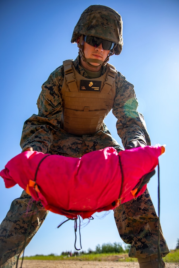 U.S. Marine Corps Lance Cpl. Logan Cormier, an expeditionary airfield technician with Marine Wing Support Squadron 471, Marine Aircraft Group 41, 4th Marine Aircraft Wing, places sandbags down during a Forward Arming Refueling Point operation at Cold Lake Air Weapons Range, Alberta, Canada, June 18, 2019, in support of Sentinel Edge 19. Exercises like SE19 ensure MARFORRES is a proficient force, ready for world-wide deployment at any given time. (U.S. Marine Corps photo by Sgt. Andy O. Martinez)