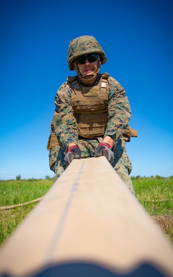 A U.S. Marine with Marine Wing Support Squadron 471, Marine Aircraft Group 41, 4th Marine Aircraft Wing, pulls a fuel hose during a Forward Arming Refueling Point operation at Cold Lake Air Weapons Range, Alberta, Canada, June 18, 2019, in support of Sentinel Edge 19. Exercises like SE19 ensure MARFORRES is a proficient force, ready for world-wide deployment at any given time. (U.S. Marine Corps photo by Sgt. Andy O. Martinez)