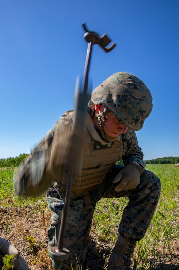A U.S. Marine with Marine Wing Support Squadron 471, Marine Aircraft Group 41, 4th Marine Aircraft Wing, emplaces a ground wire device during a Forward Arming Refueling Point operation at Cold Lake Air Weapons Range, Alberta, Canada, June 18, 2019, in support of Sentinel Edge 19. Exercises like SE19 ensure MARFORRES is a proficient force, ready for world-wide deployment at any given time. (U.S. Marine Corps photo by Sgt. Andy O. Martinez)