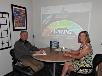 Acquisition policy community of practice team members, Wanda Cutchin and Tim Reed pose for a photo at Naval Surface Warfare Center Panama City Division. Cutchin and Reed were instrumental in the creation and continuation of the Naval Sea Systems Command Contract Management Process Guide.