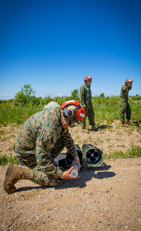 A U.S. Marine with Marine Light Attack Helicopter Squadron 775, Marine Aircraft Group 41, 4th Marine Aircraft Wing, pulls out a training rocket during Forward Arming Refueling Point operations at Cold Lake Air Weapons Range, Alberta, Canada, June 18, 2019, in support of Sentinel Edge 19. Exercises like SE19 ensure MARFORRES is a proficient force, ready for world-wide deployment at any given time. (U.S. Marine Corps photo by Sgt. Andy O. Martinez)