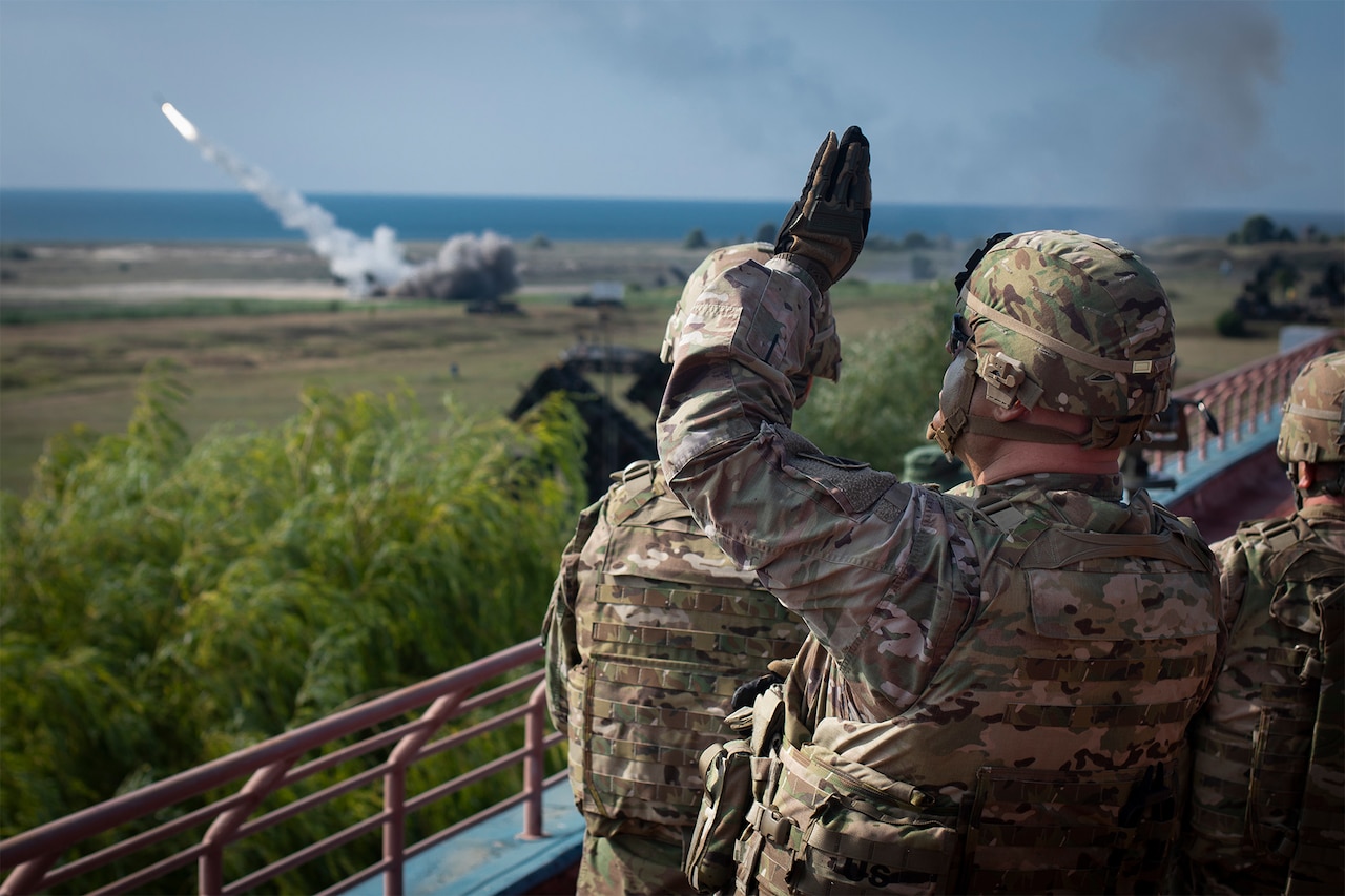 A soldier watches a missile fire.