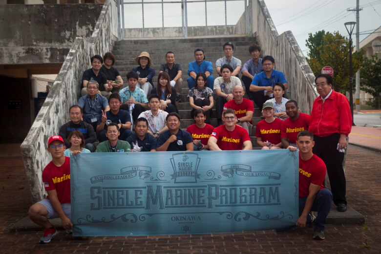 U.S. Marines and Okinawa residents pose for a group photo after the cleanup around the Ginowan convention area, Okinawa, Japan, June 19, 2019. The cleanup was held by the Okinawa Convention City Association and U.S Marines stationed on the island of Okinawa to strengthen their relationship with the residents of Okinawa. (U.S. Marine Corps photo by Cpl. Samuel Brusseau)