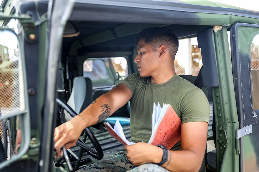 U.S. Marine Corps Lance Cpl. Kelin Cruz performs preventative maintenance checks on a Humvee June 13, 2019 at Camp Kinser, Okinawa, Japan. The checks ensure that vehicles are ready to be operated by Marines when needed. Cruz, a motor transport operator with Motor Transport Platoon, Headquarters Company, Combat Logistics Regiment 37, 3rd Marine Logistics Group, is a native of Newburgh, New York. (U.S. Marine Corps photo by Cpl. Joshua Pinkney)