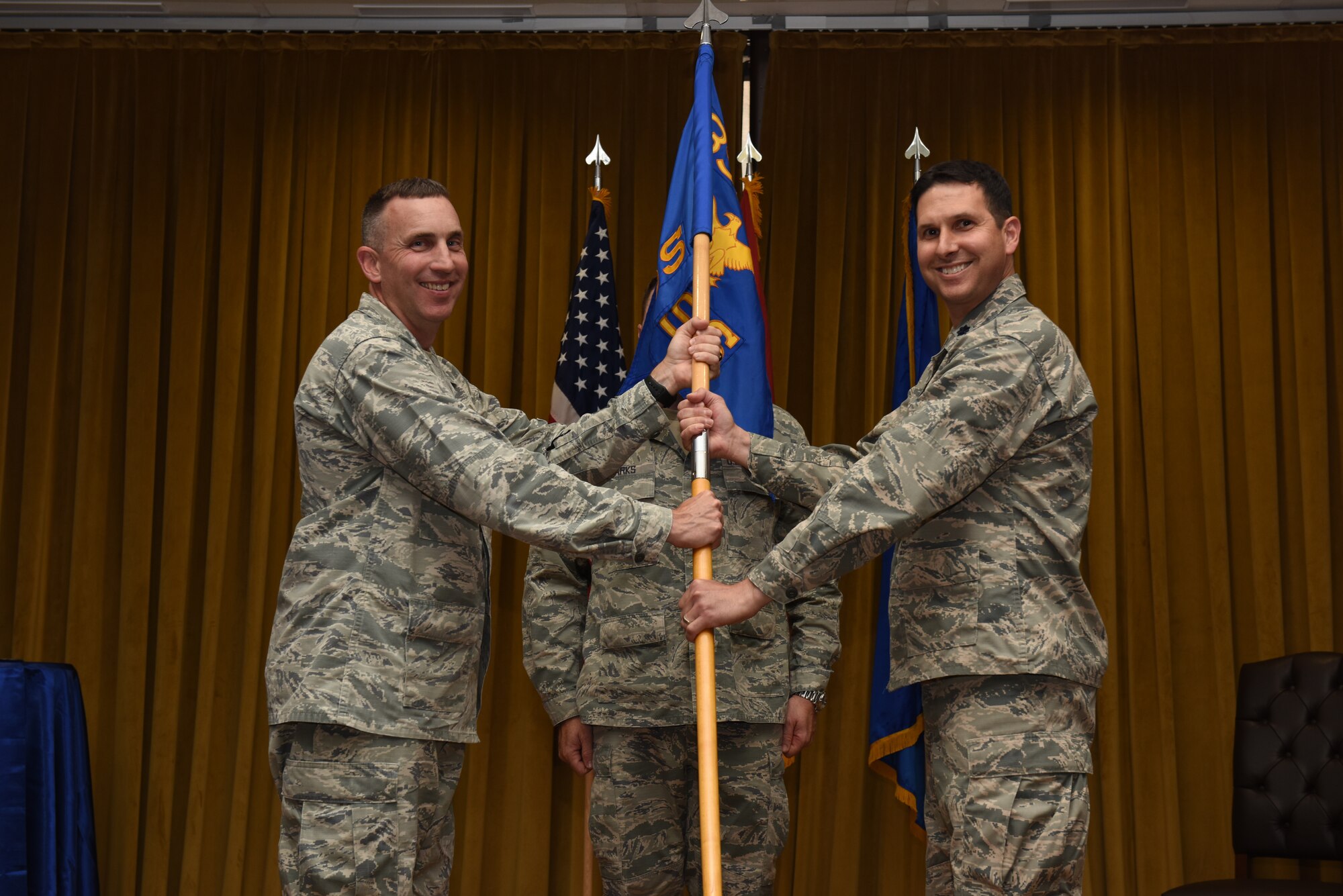 Photo of medical group commander passing command to new medical support squadron commander.