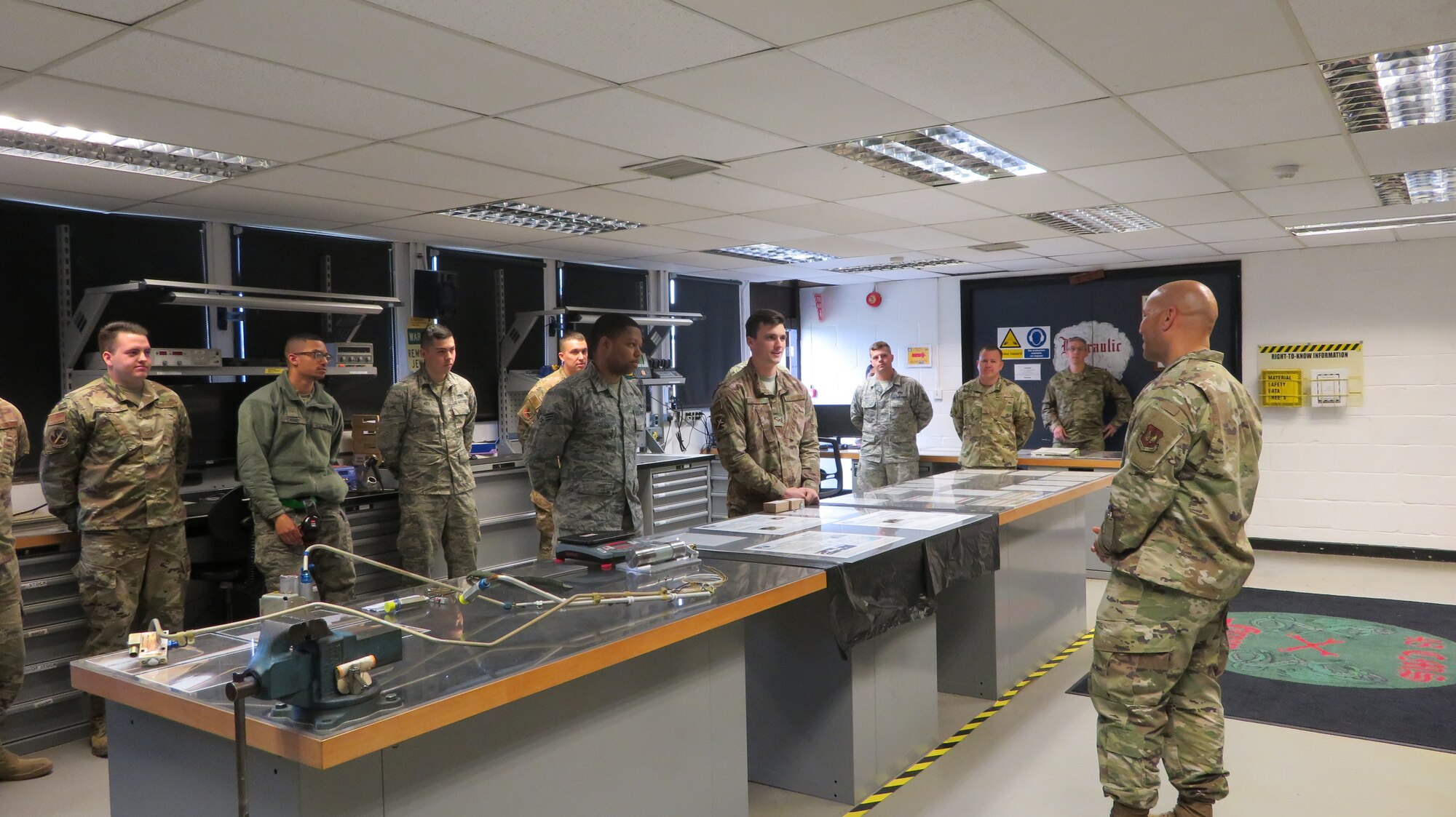 48th Component Maintenance Squadron Airmen talk to Chief Master Sgt. Daniel Guzman, U.S. Air Forces in Europe first sergeant, about their recent innovations at Royal Air Force Lakenheath, England, May 17, 2019. The Electrical and Environmental shop won two of four 2018 Wing Innovation Madness awards, which contributed to the 48th Fighter Wing 2018 Innovation Madness win at the U.S. Air Forces in Europe Africa Command level for which the wing was highlighted for saving a total of $11 million and 1.4 million man-hours. (Courtesy photo)