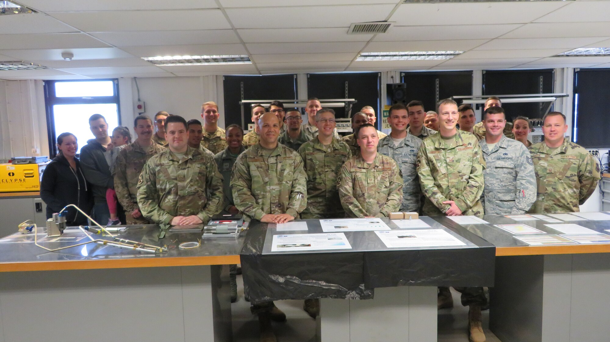 48th Component Maintenance Squadron Electrical and Environmental shop pose for a group photo with Chief Master Sgt. Daniel Guzman, U.S. Air Forces in Europe first sergeant, at Royal Air Force Lakenheath, England, May 17, 2019. The E&E shop won two of four 2018 Wing Innovation Madness awards, which contributed to the 48th Fighter Wing 2018 Innovation Madness win at the U.S. Air Forces in Europe Africa Command level for which the wing was highlighted for saving a total of $11 million and 1.4 million man-hours. (Courtesy photo)