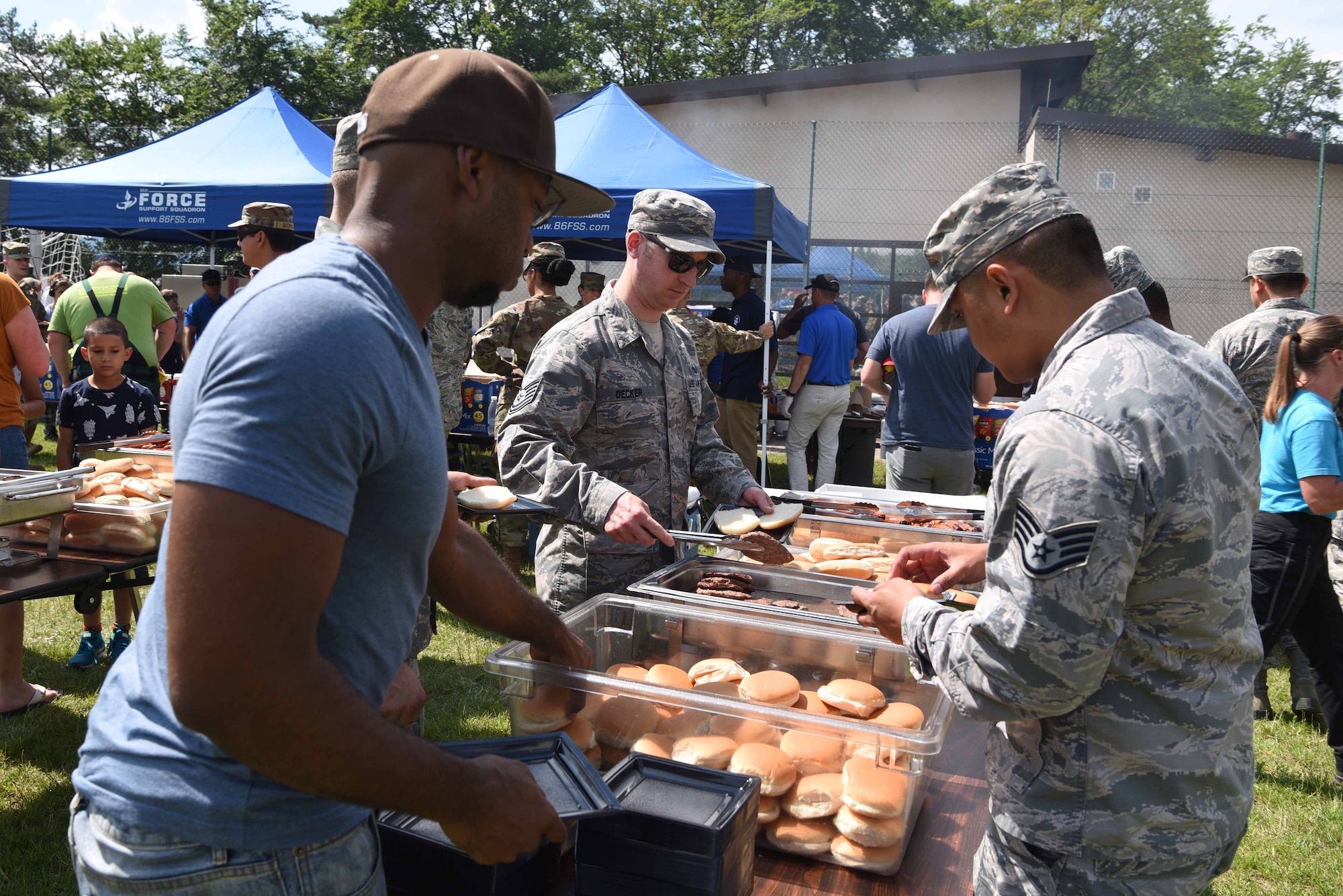 Team Ramstein Airmen and civilians prepare their plates during the Commander in Chief’s Installation Excellence Award barbecue at Donnelly Park on Ramstein Air Base, Germany, June, 18, 2019. The 86th Force Support Squadron provided all the food and entertainment for the event.