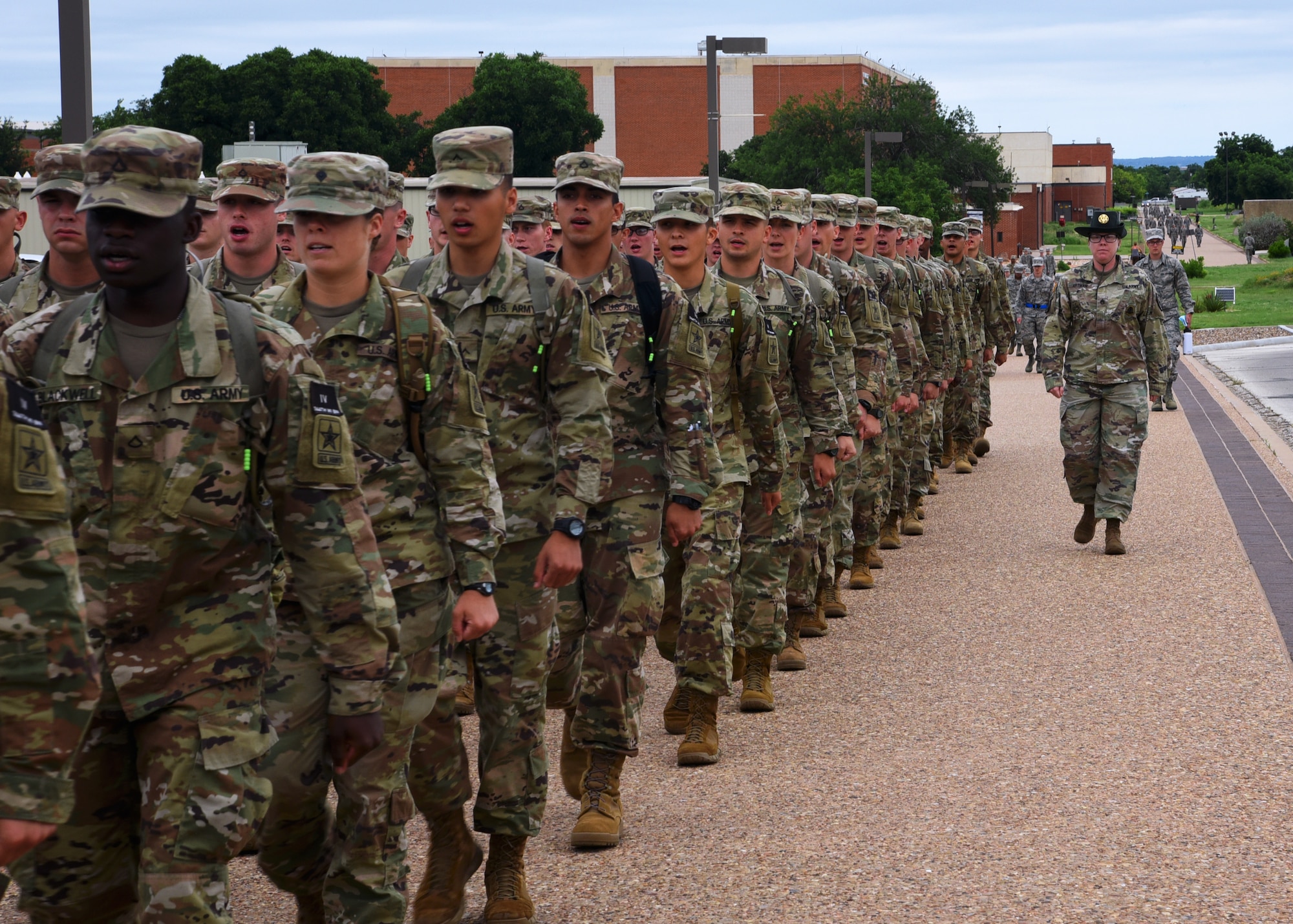 U.S. Army Staff Sgt. Sarah Artman, 344th Military Intelligence Battalion Company A drill sergeant, marches her student platoon from their signal intelligence analyst course to the Western Winds Dining Facility on Goodfellow Air Force Base, Texas, June 18, 2019. Drill sergeants develop military professionals through disciplinary techniques, such as being marched to lunch, during the Soldiers’ 24-week Advanced Individual Training on Goodfellow. (U.S. Air Force photo by Airman 1st Class Abbey Rieves/Released)