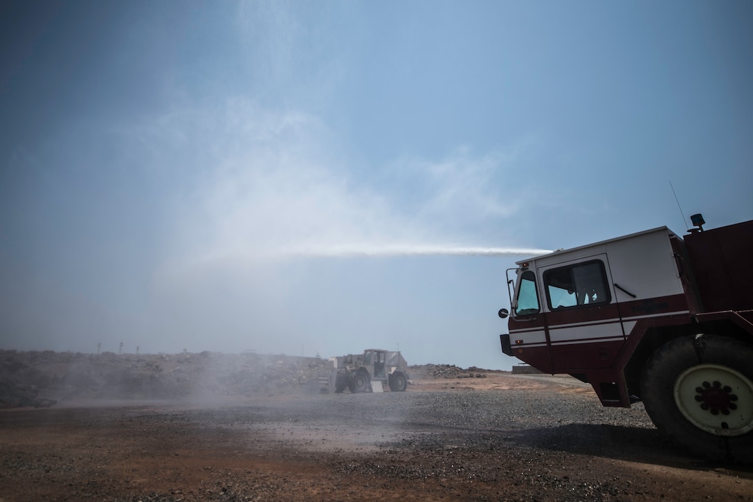 U.S. Air Force Airman 1st Class Anthon Williams, 870th Air Expeditionary Squadron firefighter, tests a fire truck hose at Chabelley Airfield, Djibouti, June 11, 2019. The 870th AES firefighters support the mission in East Africa by providing emergency services to the 449th Air Expeditionary Group and their assets. (U.S. Air Force photo by Staff Sgt. Devin Boyer)