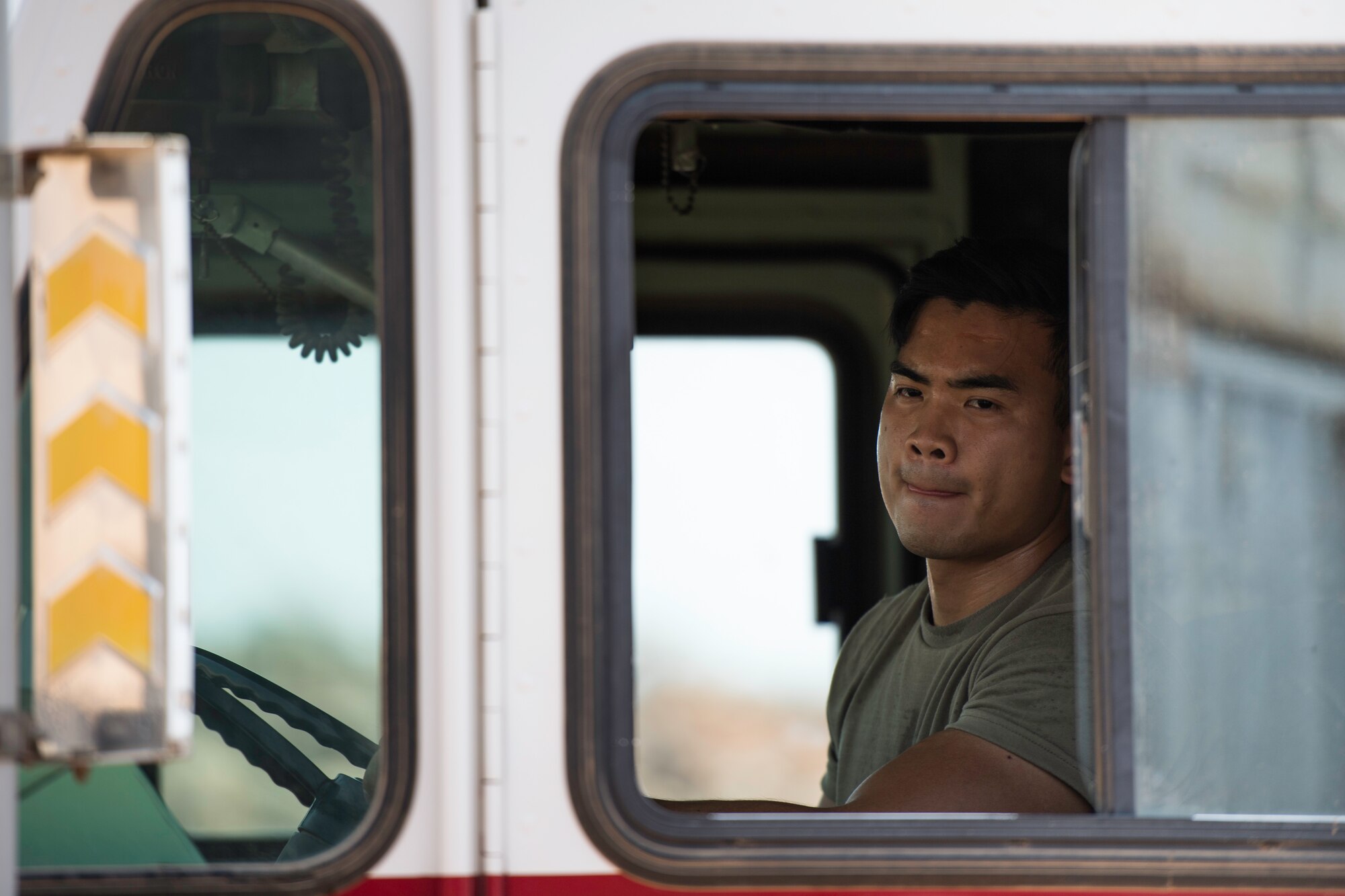 U.S. Air Force Airman 1st Class Anthon Williams, 870th Air Expeditionary Squadron firefighter, steers a fire truck at Chabelley Airfield, Djibouti, June 11, 2019. Due to the extreme temperatures in East Africa, the firefighters often perform their training early in the morning. (U.S. Air Force photo by Staff Sgt. Devin Boyer)