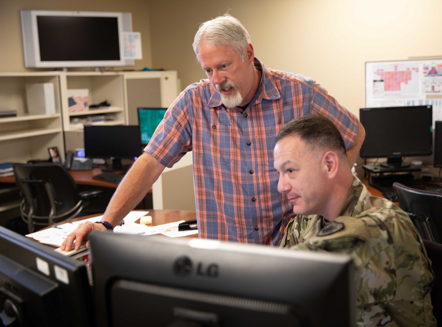 John Williams, Joint Task Force Civil Support (JTF-CS) policy and doctrine analyst, and Army Capt. Steve Elpel, JTF-CS chemical, biological, radiological, or nuclear, (CBRN) Response Planner discuss plans for upcoming exercises.  Both Williams and Capt. Elpel use their combined knowledge and planning skills in providing continued support of JTF-CS mission to the nation. JTF-CS is a standing joint task force and subordinate command of U.S. Army North (USARNORTH) charged with providing command and control of Department of Defense forces deployed to support a Lead Federal Agency in response to a CBRN incident in the United States and its territories and possessions.  (U.S. Navy Photo by Mass Communication Specialist 1st Class David Smalls, III/RELEASED)
