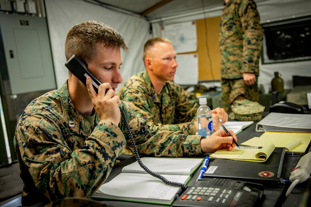 U.S. Marine Corps Capt. Robert Pleines, left, a watch officer with Marine Wing Support Squadron 471, Marine Aircraft Group 41, 4th Marine Aircraft Wing, makes a phone call at Canadian Forces Base Cold Lake, Canada, June 19, 2019, in support of Sentinel Edge 19. Training exercises, such as SE19, ensure Reserve Marines are proficient and capable of successful integration with active-duty Marines, making MARFORRES critical to the Marine Corps’ Total Force. (U.S. Marine Corps photo by Lance Cpl. Jose Gonzalez)