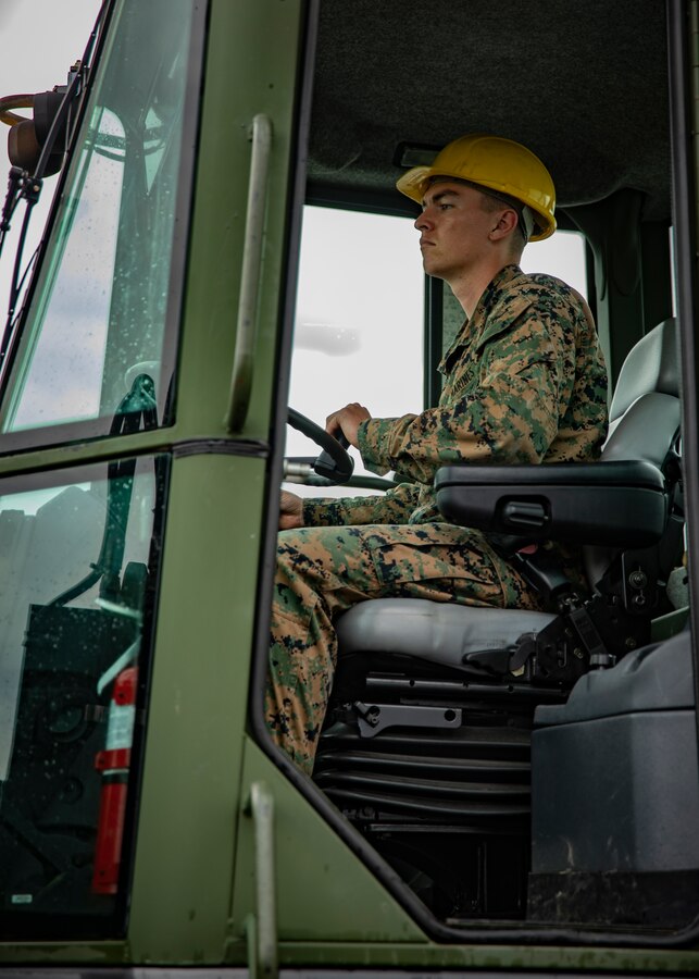 U.S. Marine Corps Cpl. Ryan Donnelly, a heavy equipment operator with Marine Wing Support Squadron 471, Marine Aircraft Group 41, 4th Marine Aircraft Wing, operates a tractor at Canadian Forces Base Cold Lake, Canada, June 19, 2019, in support of Sentinel Edge 19. Training exercises, such as SE19, ensure Reserve Marines are proficient and capable of successful integration with active-duty Marines, making MARFORRES critical to the Marine Corps’ Total Force. (U.S. Marine Corps photo by Lance Cpl. Jose Gonzalez)