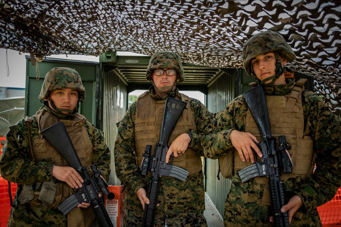 U.S. Marine Corps Lance Cpl. Jesper Yan, left; Lance Cpl. Marc Hargrove, center, and Pfc. Brendan Howells, right, all base security with Marine Wing Support Squadron 471, Marine Aircraft Group 41, 4th Marine Aircraft Wing, guard an entrance at Canadian Forces Base Cold Lake, Canada, June 19, 2019, in support of Sentinel Edge 19. Training exercises, such as SE19, ensure Reserve Marines are proficient and capable of successful integration with active-duty Marines, making MARFORRES critical to the Marine Corps’ Total Force. (U.S. Marine Corps photo by Lance Cpl. Jose Gonzalez)