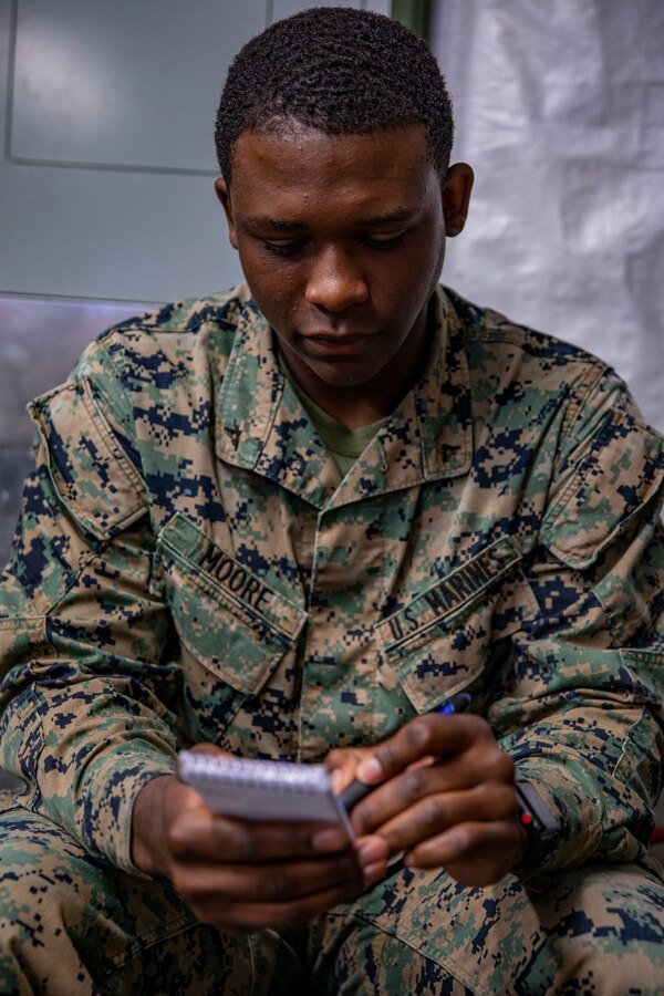 U.S. Marine Corps Lance Cpl. Taivin Moore, a scribe with Marine Wing Support Squadron 471, Marine Aircraft Group 41, 4th Marine Aircraft Wing, writes on a notepad at Canadian Forces Base Cold Lake, Canada, June 19, 2019, in support of Sentinel Edge 19. Training exercises, such as SE19, ensure Reserve Marines are proficient and capable of successful integration with active-duty Marines, making MARFORRES critical to the Marine Corps’ Total Force. (U.S. Marine Corps photo by Lance Cpl. Jose Gonzalez)