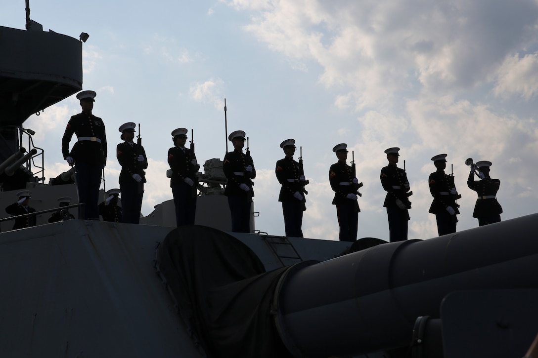 Marines from Marine Corps Base Camp Lejeune stand at present arms during the playing of taps during the 58th annual Memorial Day Observance ceremony aboard the USS North Carolina in Wilmington, North Carolina, May 27. Hundreds of veterans, friends, family members and community leaders honored those who lost their lives in military service of the United States during the 58th annual Memorial Day Observance ceremony. Marines from MCB Camp Lejeune also served as color guard and ceremonial detail.