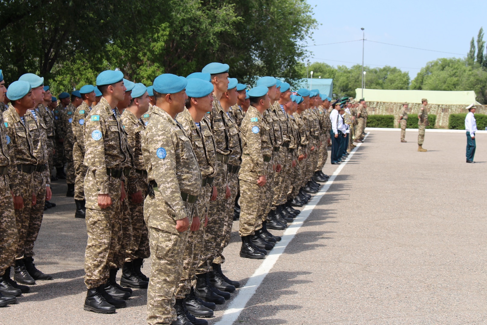 Kazakhstani Ground Forces' Soldiers stand in formation alongside Soldiers from other participating nations at the opening ceremony for Steppe Eagle 19, June 17, 2019, at Illisky Training Area near Almaty, Kazakhstan. Steppe Eagle 19 is a U.S. Army Central-led exercise that promotes regional stability and interoperability in the Central and South Asia region. (Photo by U.S. Army Maj. Kevin Sandell)