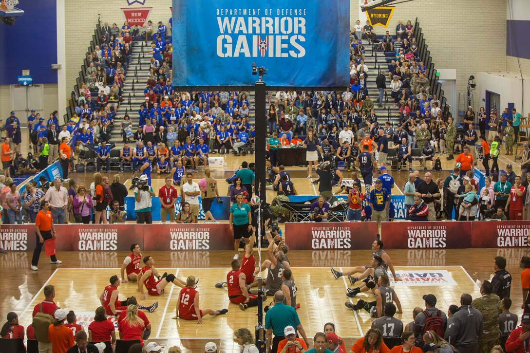 Team Marine Corps plays a 2018 DoD Warrior Games sitting volleyball preliminary match against Team SOCOM at the Air Force Academy in Colorado Springs, Colorado, June 3, 2018. The Warrior Games is an adaptive sports competition for wounded, ill and injured service members and veterans. Approximately 300 athletes representing teams from the Marine Corps, Navy, Army, Air Force, Special Operations Command, United Kingdom Armed Forces, Canadian Armed Forces, and the Australian Defence Force will compete June 1 - June 9 in archery, cycling, track, field, shooting, sitting volleyball, swimming, wheelchair basketball, and - new this year - powerlifting and indoor rowing.