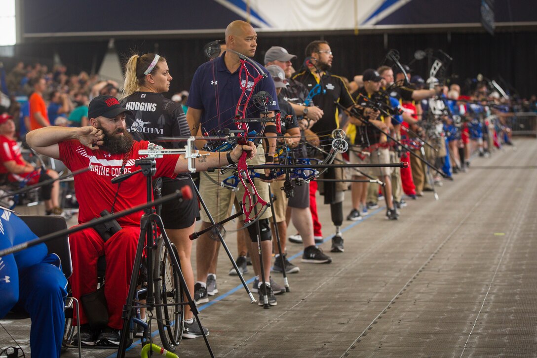 U.S. Marine Corps veteran Douglas Godfrey Jr., a native of Woodbridge, Virginia, releases an arrow at the 2018 DoD Warrior Games Archery Competition at the Air Force Academy in Colorado Springs, Colorado, June 7, 2018. The Warrior Games is an adaptive sports competition for wounded, ill and injured service members and veterans. Approximately 300 athletes representing teams from the Marine Corps, Navy, Army, Air Force, Special Operations Command, United Kingdom Armed Forces, Canadian Armed Forces, and the Australian Defence Force will compete June 1 - June 9 in archery, cycling, track, field, shooting, sitting volleyball, swimming, wheelchair basketball, and - new this year - powerlifting and indoor rowing.