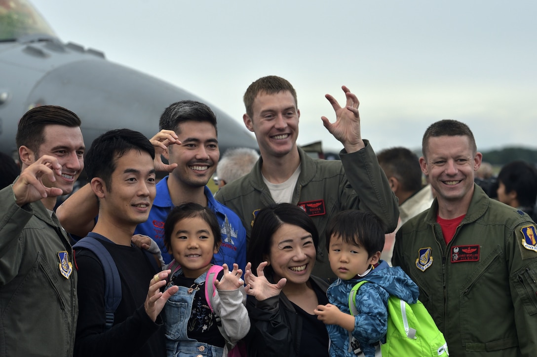 Pilots with the 13th Fighter Squadron pause for photographs with Japanese nationals during the Misawa Friendship Festival 2018 at Misawa Air Base, Japan, Sept. 9, 2018. The festival featured more than 15 aircraft displays, 60 vendors and multiple ground demonstrations throughout the day.