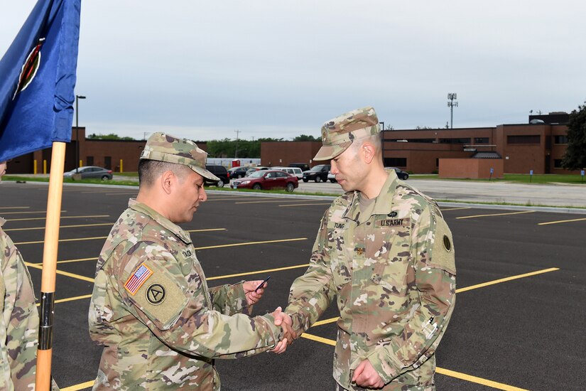 Maj. Christopher Tung, right, receives the Army Fitness Badge during the 85th U.S. Army Reserve Support Command headquarters weekend battle assembly, June 8, 2019.