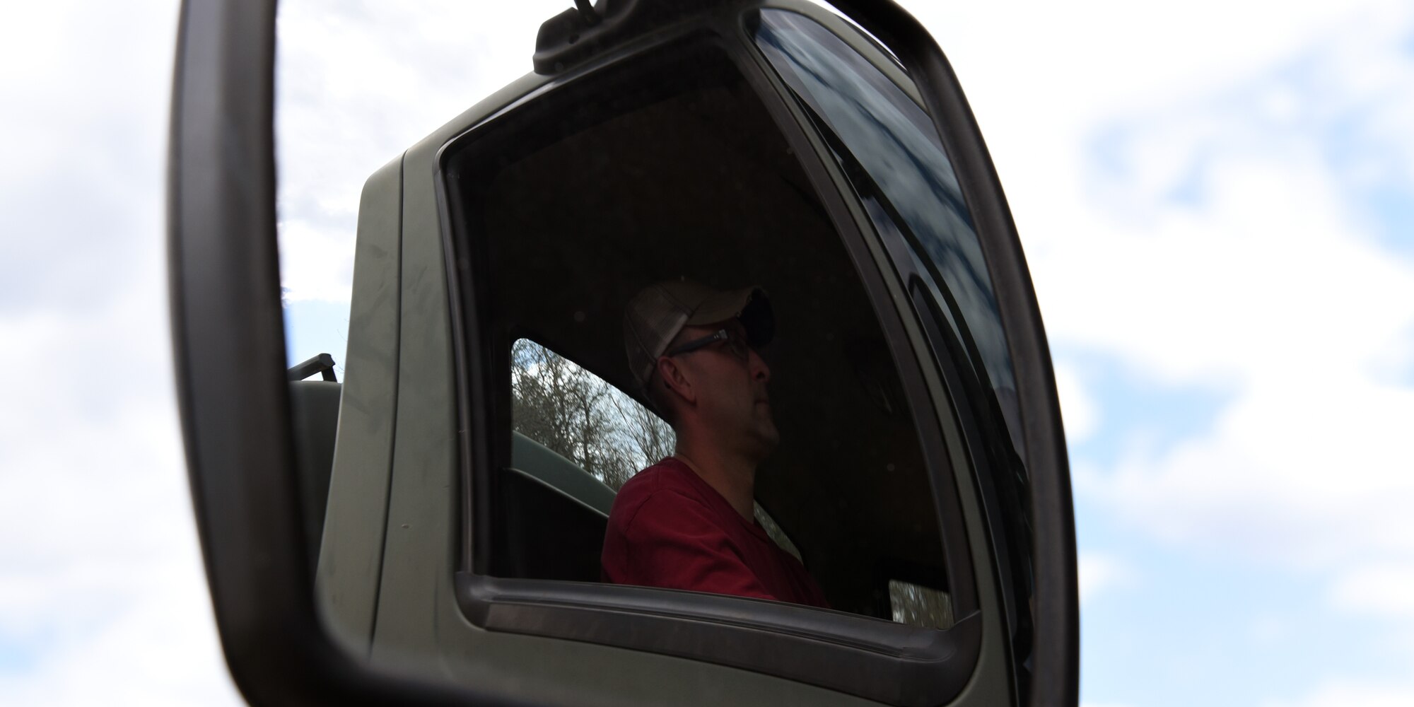 Staff Sgt. Allen D. Hughes, playing the bad guy and on the move in his water truck. Hughes was taking directions from joint terminal attack controller trainers, who were running scenarios for their students as part of exercise Northern Lightning, May 6-17, 2019.  (U.S. Air National Guard photo by Master Sgt. Erik J. Figi)