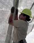 Tech. Sgt. Shasta Pesquera, a member of the 149th Force Support Squadron, assembles a small shelter system during Home Station Readiness Training in California at March Air Reserve Base ‪June 17-2‬2. The small shelter system is a tent that can be used for lodging, fitness or recreation when hardened facilities are not available.