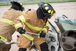 Firefighters from the Army of the Czech Republic air forces remove a door from a vehicle during training with the 155th Air Refueling Wing fire department June 6, 2019, at the Nebraska National Guard air base in Lincoln, Nebraska. This Nebraska National Guard and Czech Republic armed forces training exchange is one of many facilitated by the National Guard’s State Partnership Program.