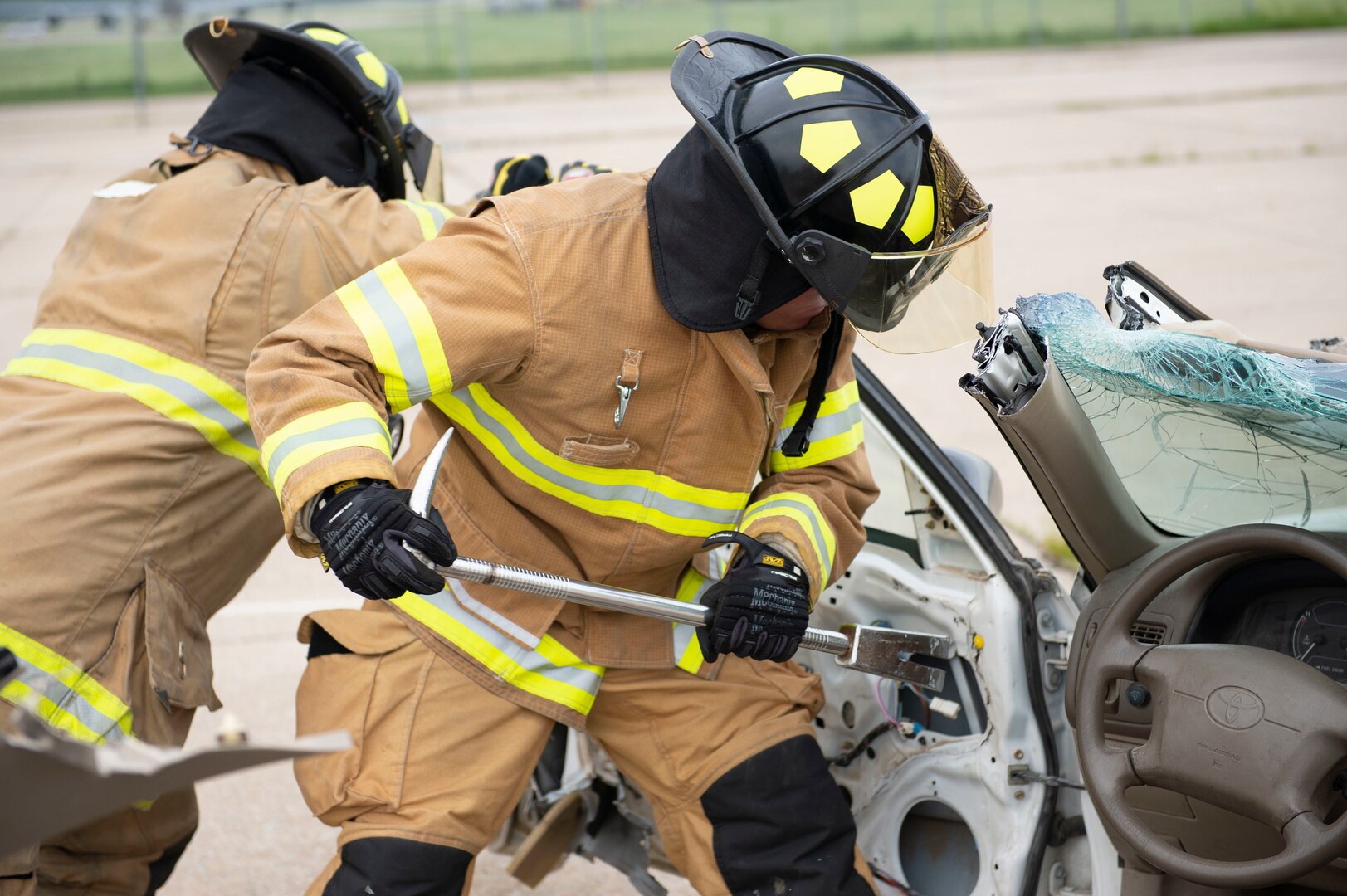 Firefighters from the Army of the Czech Republic air forces remove a door from a vehicle during training with the 155th Air Refueling Wing fire department June 6, 2019, at the Nebraska National Guard air base in Lincoln, Nebraska. This Nebraska National Guard and Czech Republic armed forces training exchange is one of many facilitated by the National Guard’s State Partnership Program.