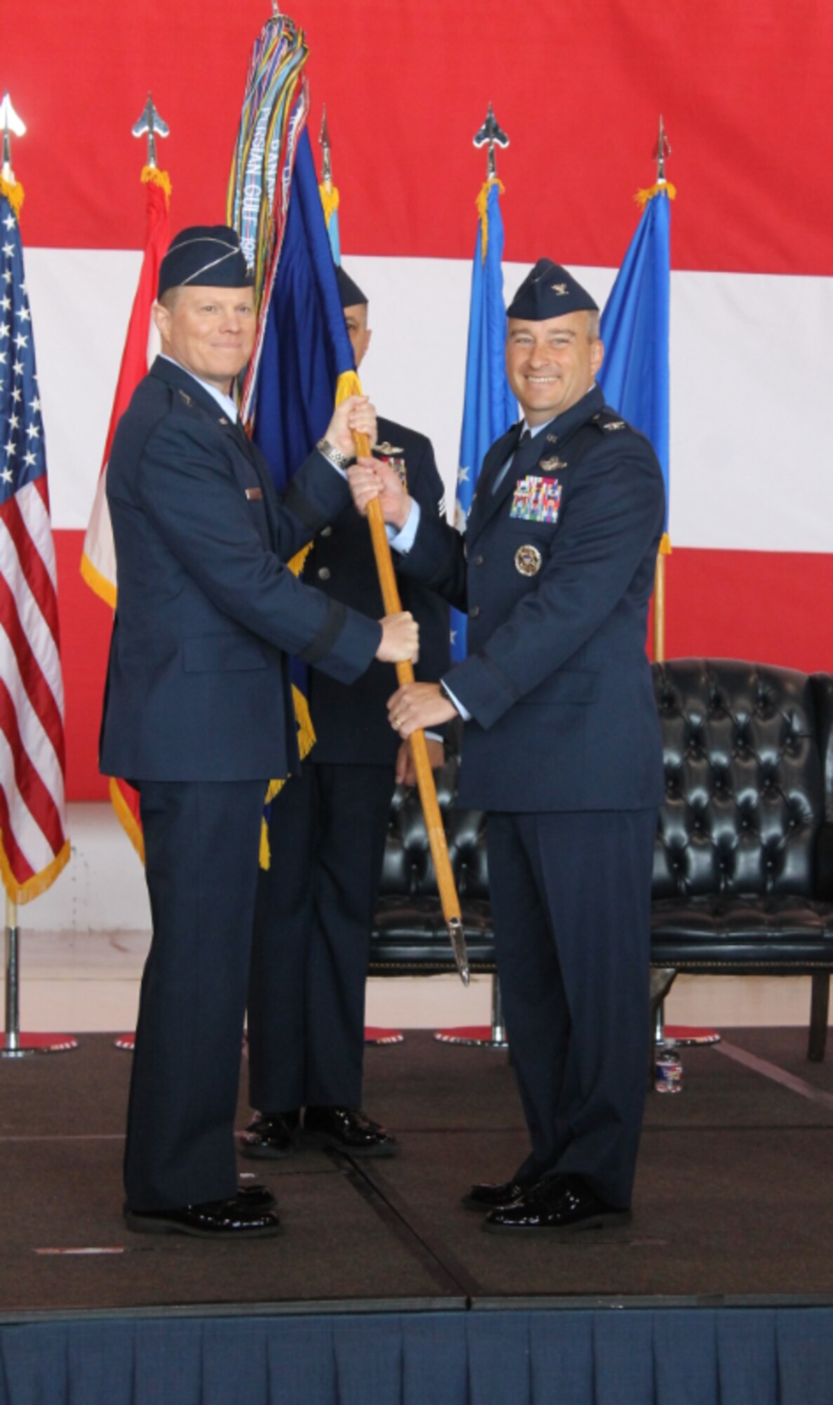 Col. Alain D. Poisson, right, accepts the guideon for the 552nd Air Control Wing from Maj. Gen. Andrew A. Croft, 12th Air Force (Air Forces Southern) commander, during the change of command ceremony June 10, 2019, Tinker Air Force Base, Oklahoma. Col. Geoffrey Weiss relinquished command of the 552 ACW to Col. Alain D. Poisson. (U.S. Air Force photo/2nd Lt. Ashlyn K. Paulson)