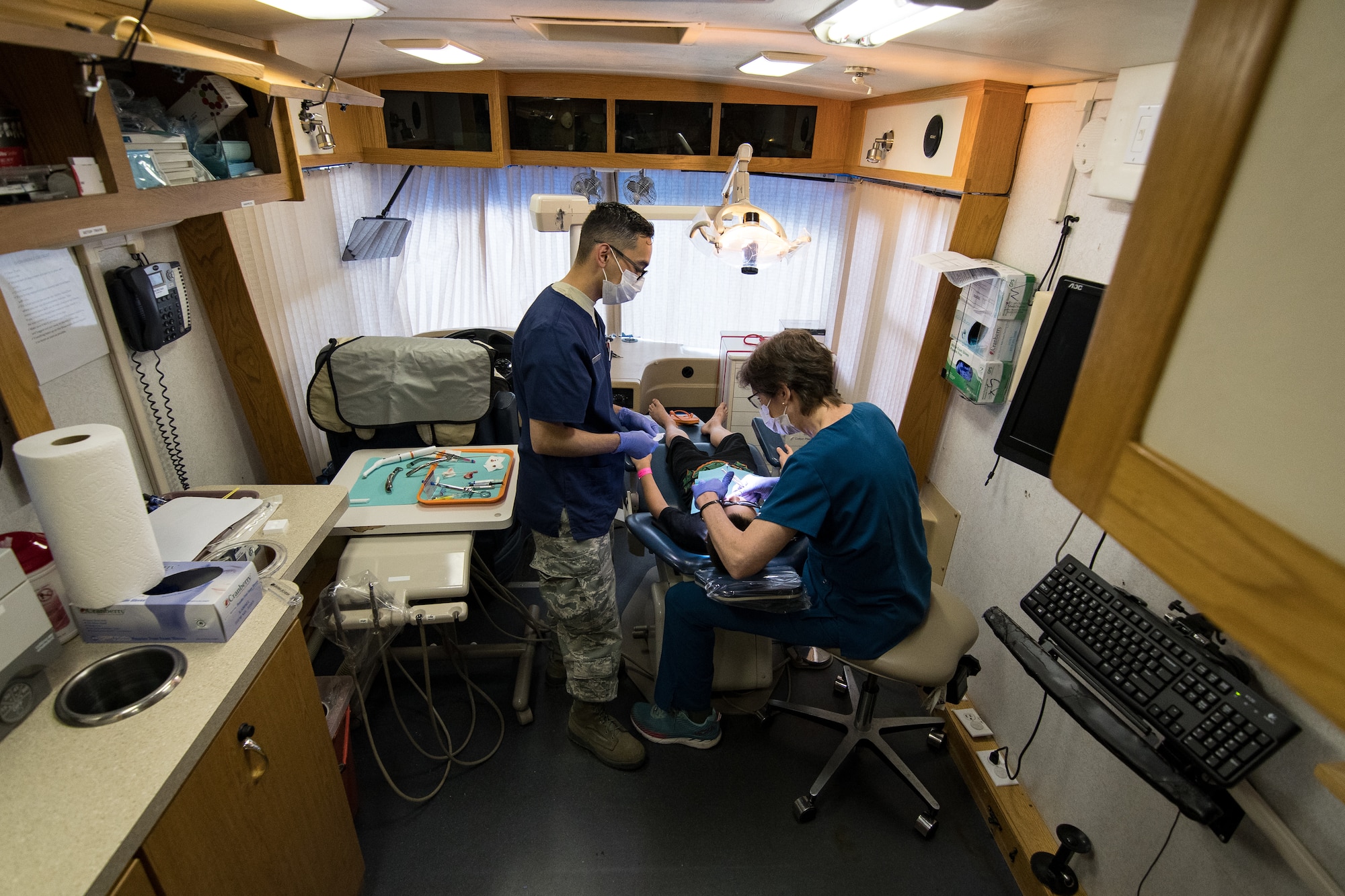 U.S. Air Force Tech Sgt. Eddie Perez, a dental technician, and Lt. Col. Julie Robinson, the dental officer-in-charge for Delta Area Economic Opportunity Corporation Tri-State Innovative Readiness Training 2019 and a dentist, both assigned to the 176th Wing, Alaska Air National Guard, perform a tooth extraction procedure at a temporary clinic in Sikeston, Missouri, June 19, 2019. Perez and Robinson deployed to Sikeston as part of a joint service medical exercise that provides training to service members and no-cost medical services to the community. (U.S. Air National Guard photo by Senior Airman Jonathan W. Padish)