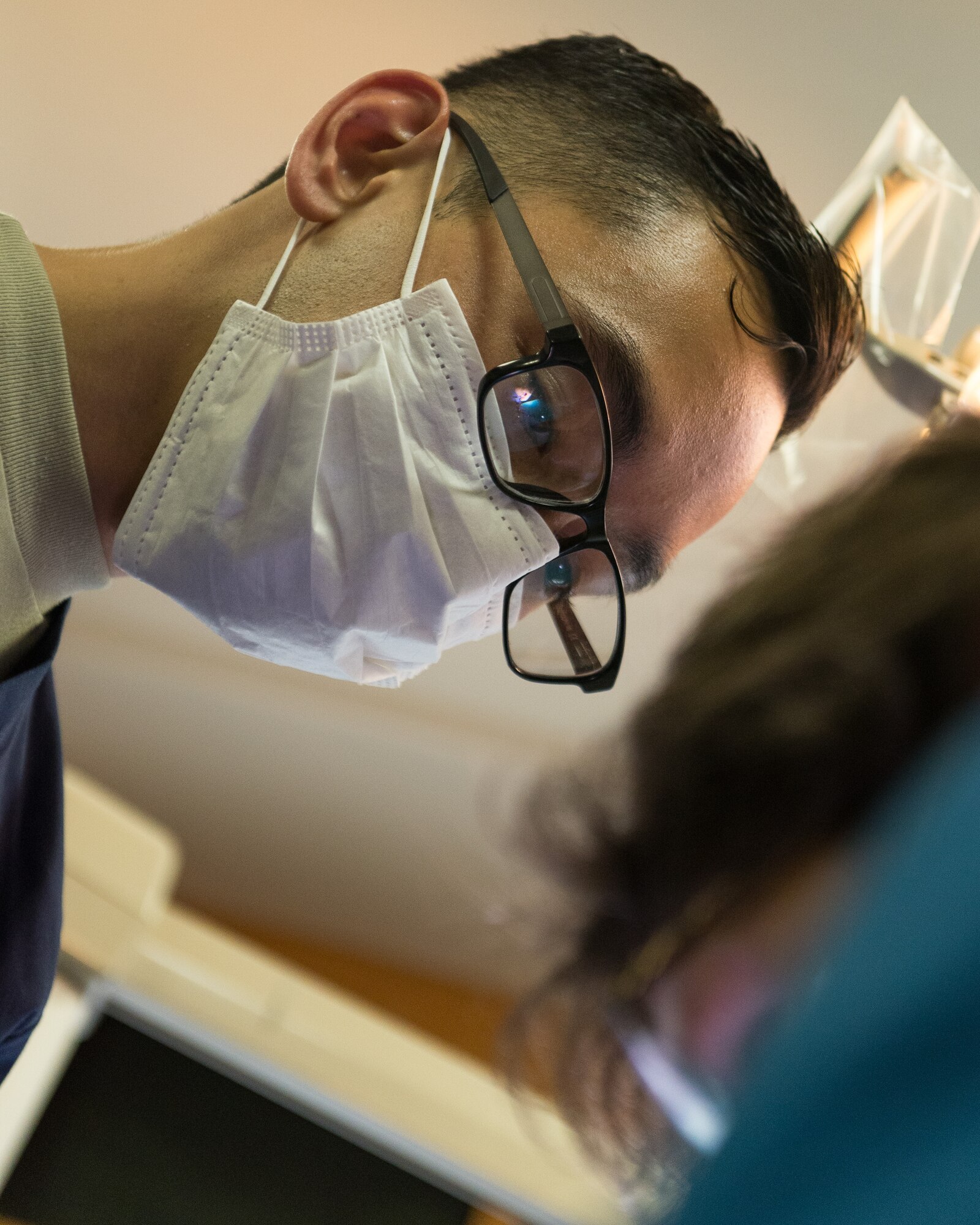 U.S. Air Force Tech Sgt. Eddie Perez, a dental technician assigned to the 176th Wing, Alaska Air National Guard, assists with a tooth extraction procedure at a temporary clinic in Sikeston, Mo., June 19, 2019. U.S. service members deployed to Sikeston as part of a joint service medical exercise that provides training to service members and no-cost medical services to the community. (U.S. Air National Guard photo by Senior Airman Jonathan W. Padish)