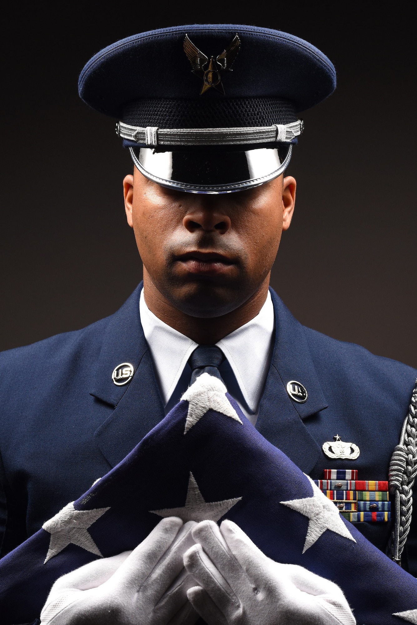 Honor Guard program manager grips a folded flag