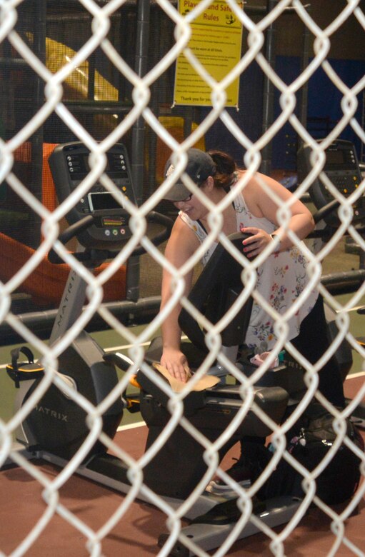 Kristina Plichta gets set to work out at the Offutt Field House’s newly remodeled Children’s Play Area. The new location eliminates the risk of children entering the running track and being injured. The biggest change has been the addition of a weights area. In the previous location there was no room inside of the play area for parents who use weights.