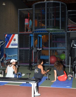 Patrons work out and socialize at the Offutt Field House’s newly relocated Children’s Play Area. The new CPA features all self-propelled exercise equipment that does not require wires or power cords to minimize safety risks to children in the area along with a play area to keep them occupied and active while their parents workout.
