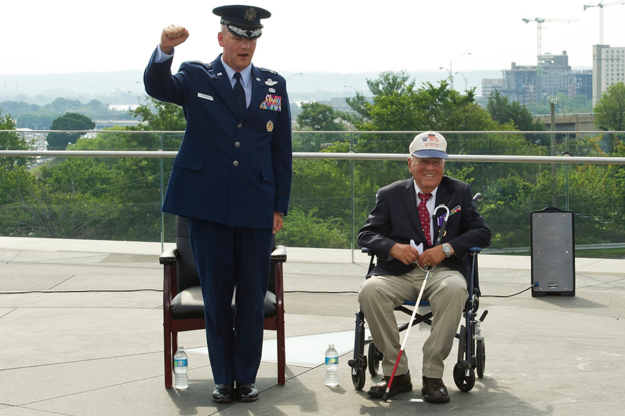 ARLINGTON, Va. --Maj. Gen. James Jacobson, Air Force District of Washington commander, and 2nd Lt. John Pedevillano sing the Air Force song  following a Purple Heart presentation ceremony in Pedevillano�s honor at the Air Force Memorial, Jul. 14, 2017.  Pedevillano, a B-17 bombardier pilot, received the award for wounds he incurred during a forced march as a World War II prisoner of war.  Pedevillano also received tokens of appreciation from both the Secretary and Chief of Staff of the Air Force.